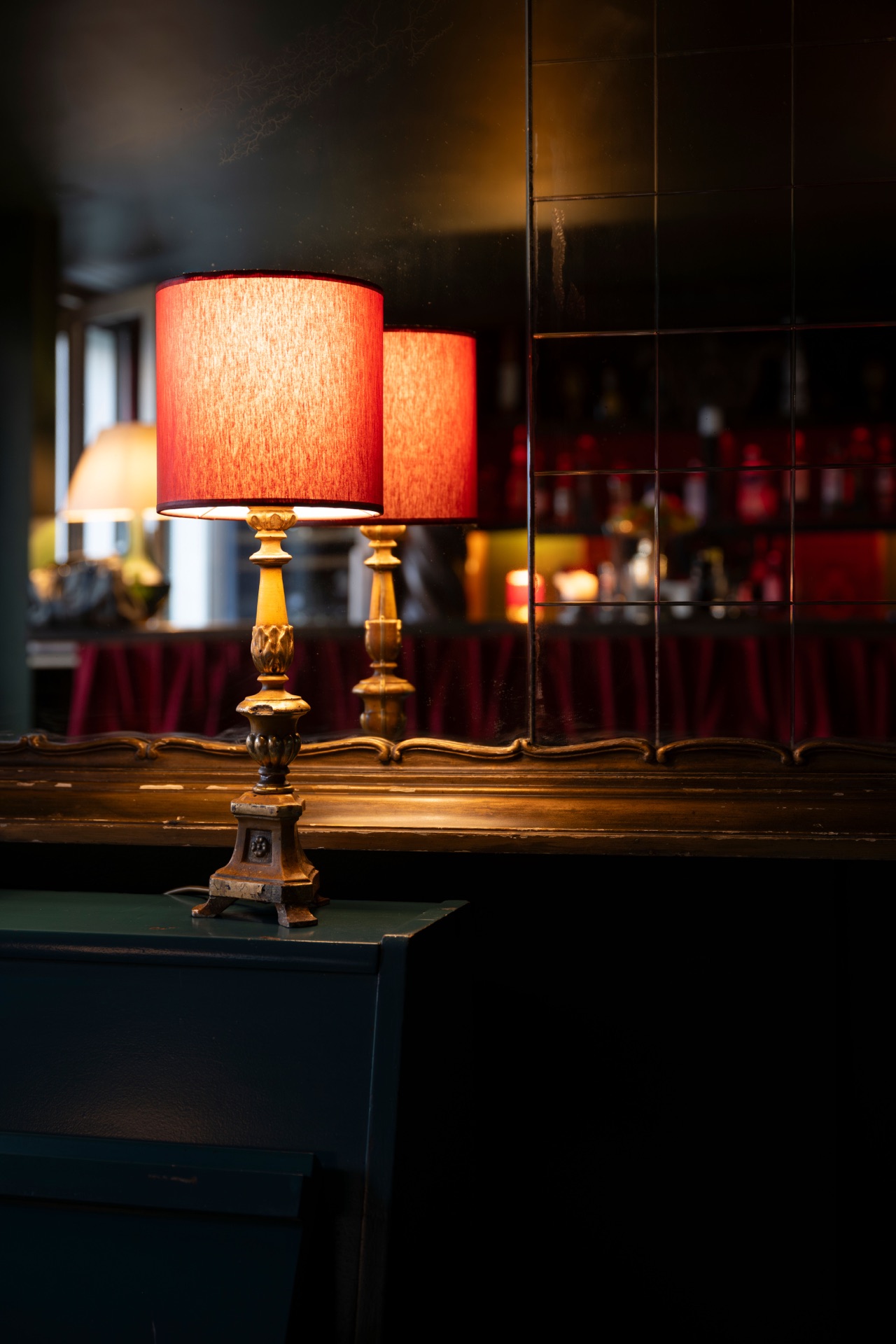 A sculptural lamp glowing against dark panelling