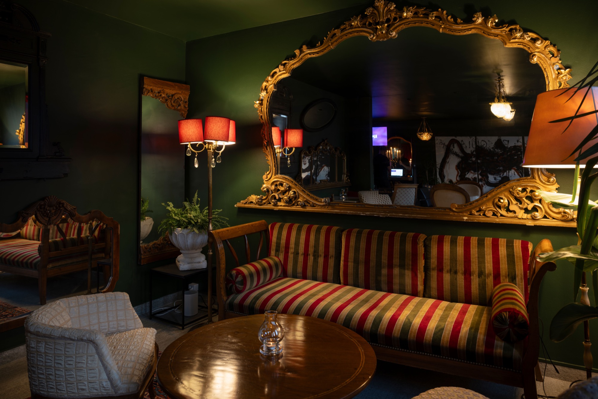The Le Bar lounge — gilt mirror and striped sofa