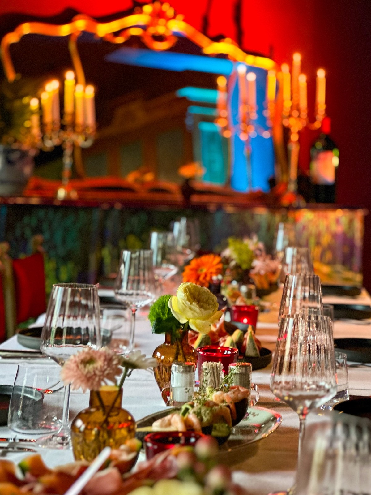 A long candlelit dinner table set for guests at Villa Beaulieu