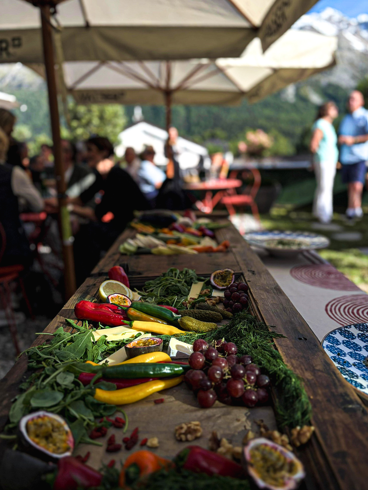 The long table set for aperitifs, mountains beyond