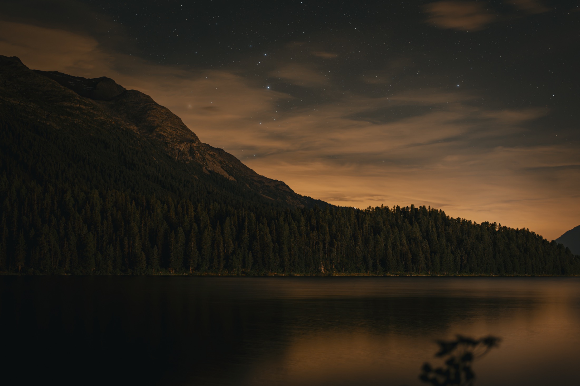 Lake St. Moritz at dusk with village and peaks